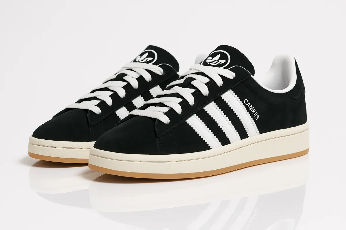 Adidas Campus 00s in black suede with contrasting white three stripes, featuring classic low-profile silhouette, vintage-inspired design, trefoil logo on tongue, and cream-colored midsole with gum rubber outsole.