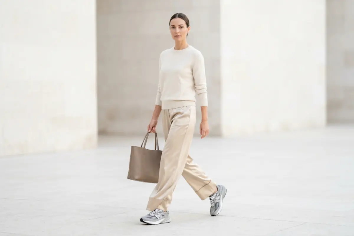 Neutral daily trainers styled with quiet luxury wide-leg trousers for an elegant everyday look.