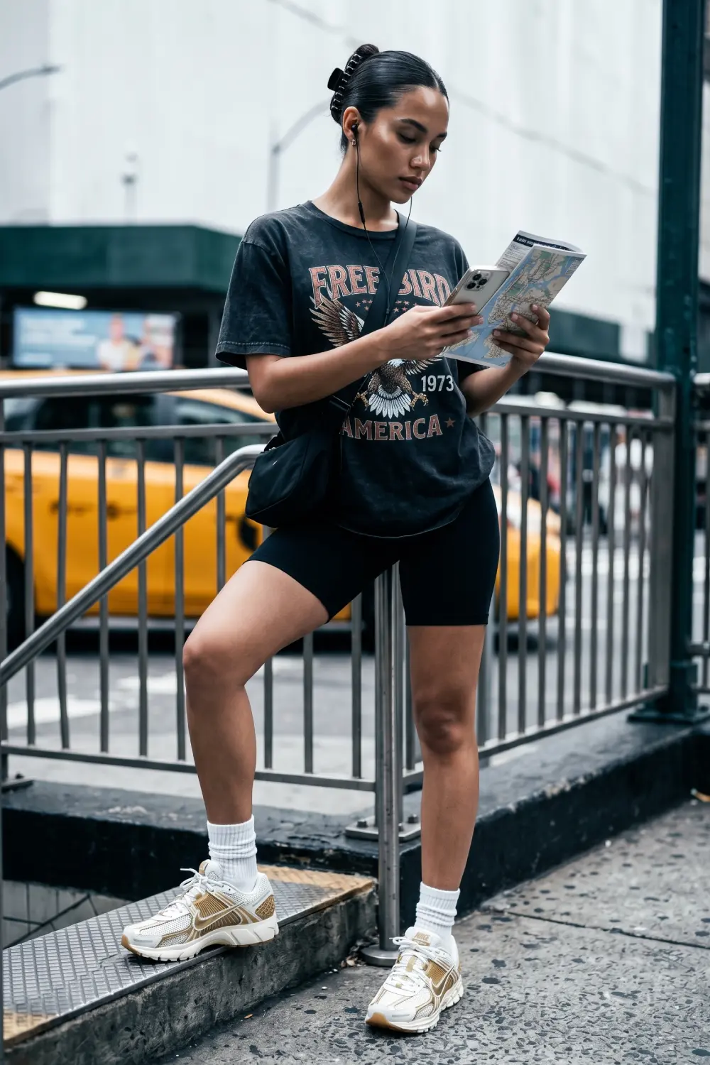 Minimal athleisure summer outfit featuring silver Nike Zoom Vomero 5 breathable sneakers and compressive black biker shorts.