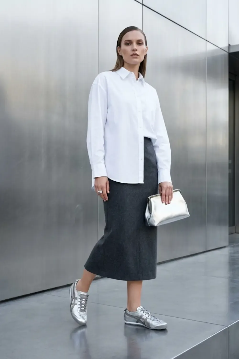 A trend-forward woman styling metallics for daytime, capturing a sophisticated 'Metropolis Minimalist' look.
