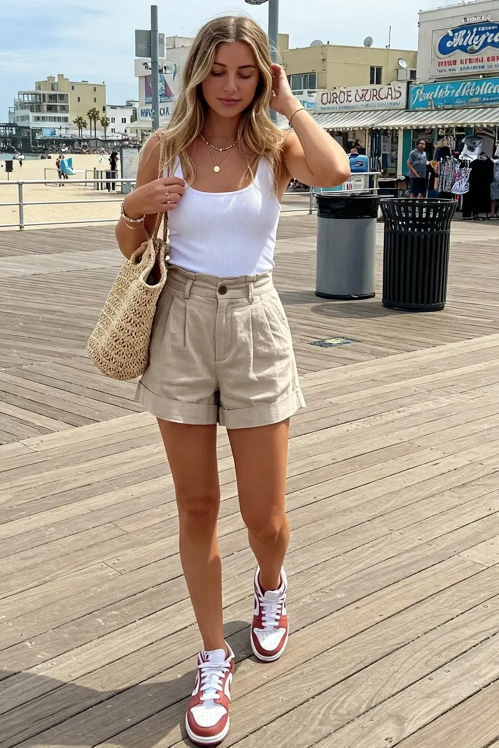 Woman wearing Nike Dunk Lows with beige linen shorts and a white tank top for a chic, breathable summer outfit.