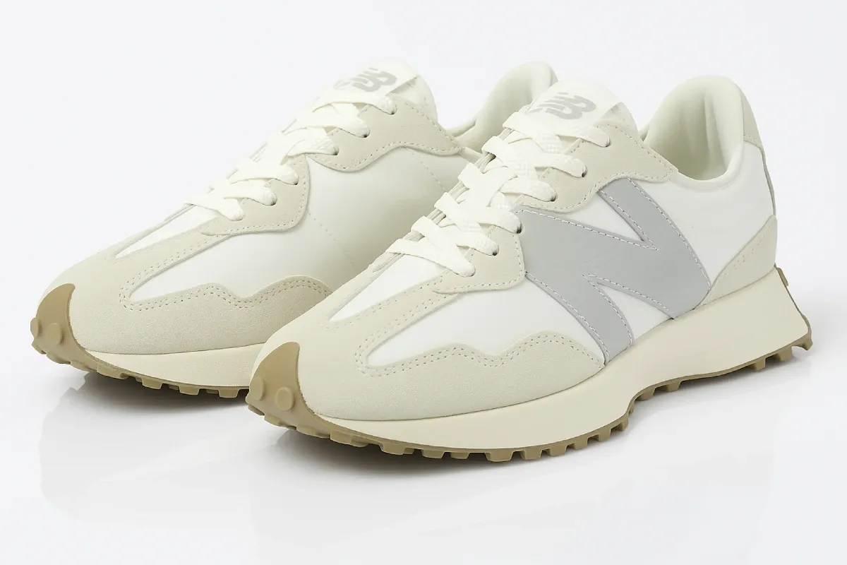 New Balance 327 in cream/off-white colorway with light grey N logo, featuring streamlined retro-inspired silhouette, suede and leather construction, distinctive angular design, and textured gum outsole for vintage casual appeal.