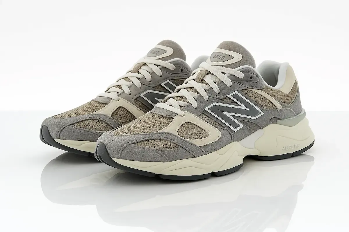 New Balance 9060 in gray/beige colorway featuring premium suede and mesh upper, ABZORB cushioning, chunky midsole, reflective N logo, maximalist design aesthetic, and multi-layered construction with retro-futuristic appeal.