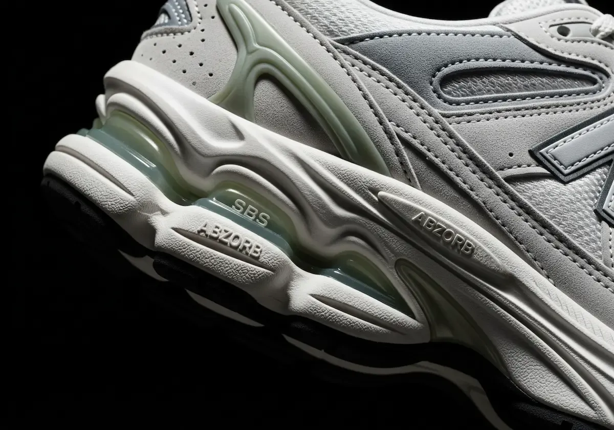 A detailed close-up shot of the New Balance 9060's exaggerated midsole, showing the sculpted pods and visible windows that contain the ABZORB and SBS cushioning technology.