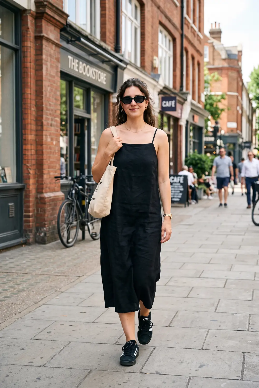Effortless summer women's normcore style with a black midi linen dress and Adidas Campus 00s sneakers.