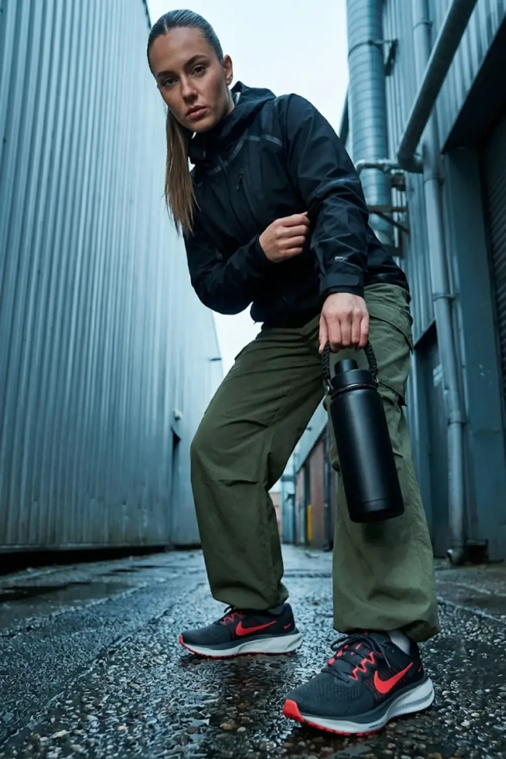 A tech-savvy woman with an 'Urban Explorer' aesthetic and Nike Zoom Vomero 18