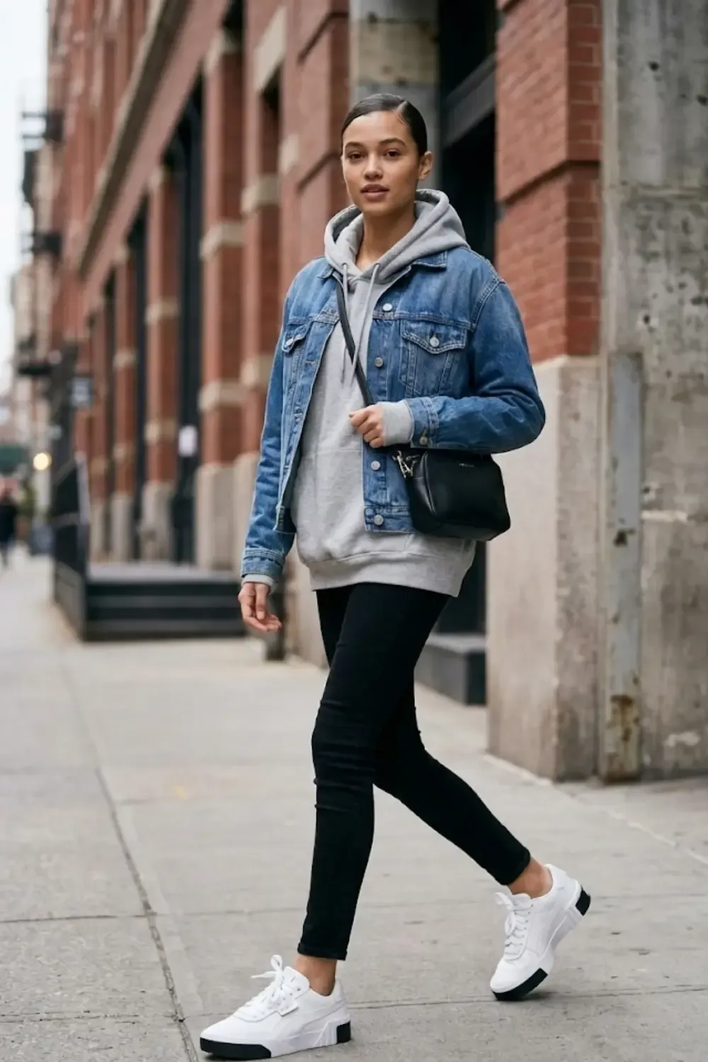 Modern city woman in layered street style with Puma Cali sneakers