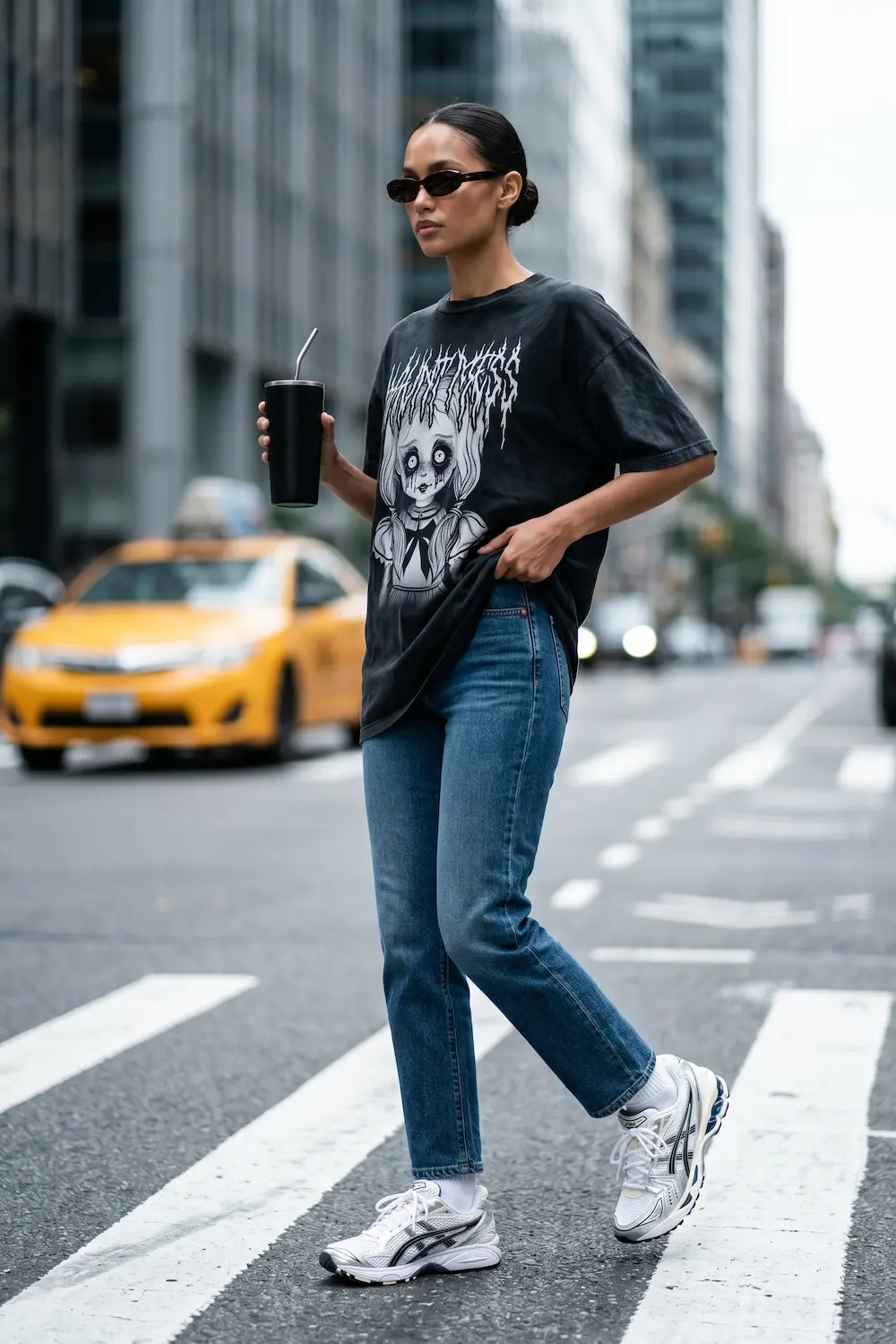 Bella Hadid's off-duty street style featuring an oversized graphic tee and ASICS Gel-Kayano 14s.