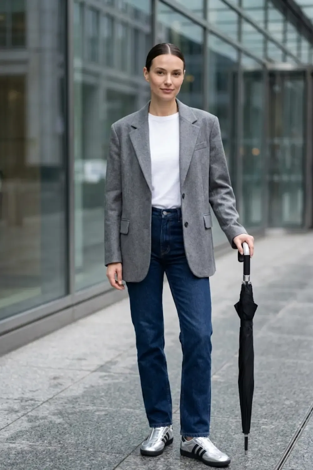 A creative professional woman demonstrating the 'Sandwich Method' for a polished office look. With Adidas Taekwondo